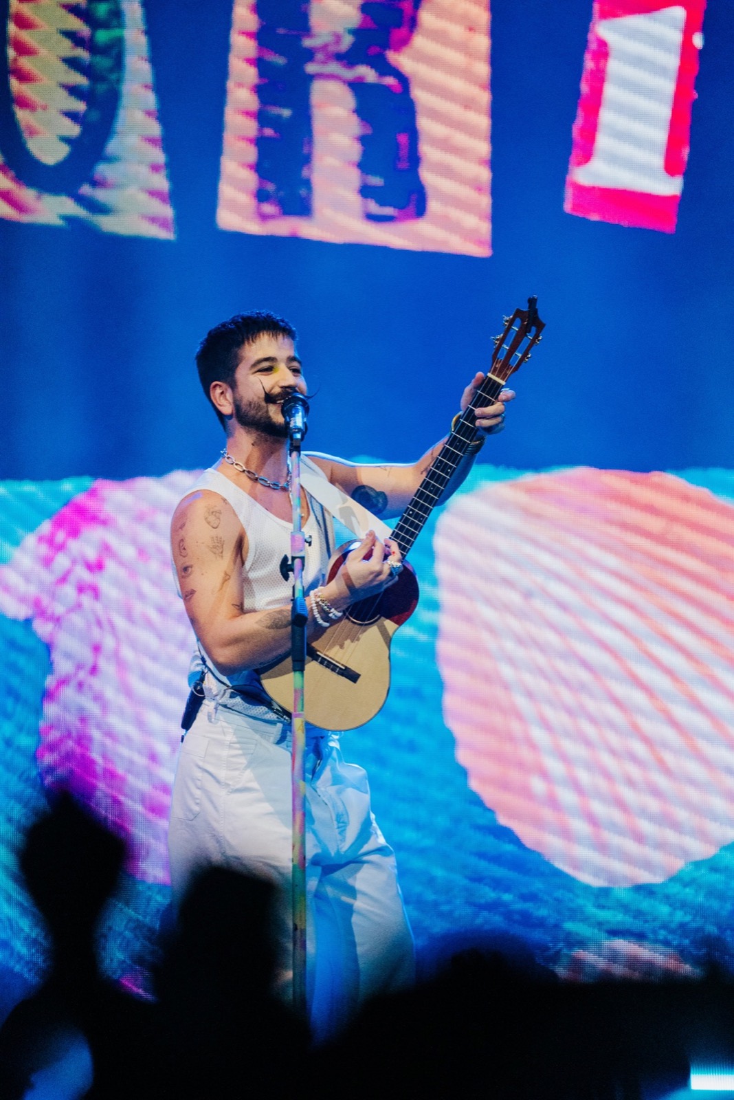 Camilo with guitar in front of the LED wall