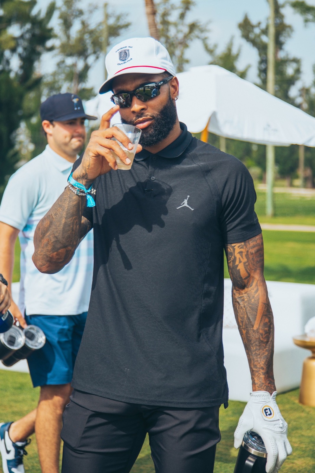 Athlete in a black polo on the golf course