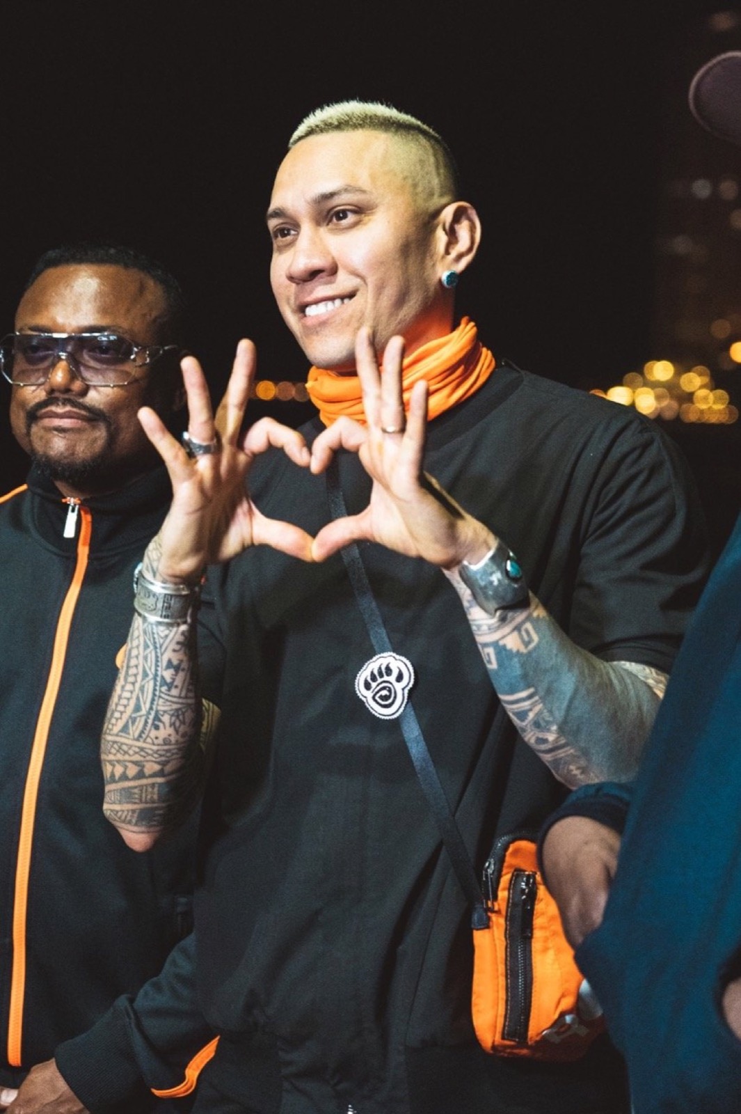 Two artists making a heart with their hands