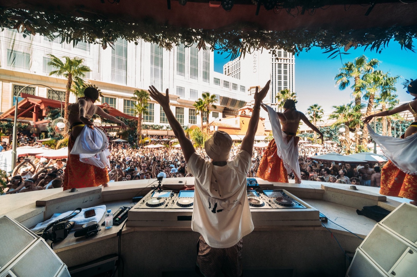 Pool party DJ set with hands up in the crowd