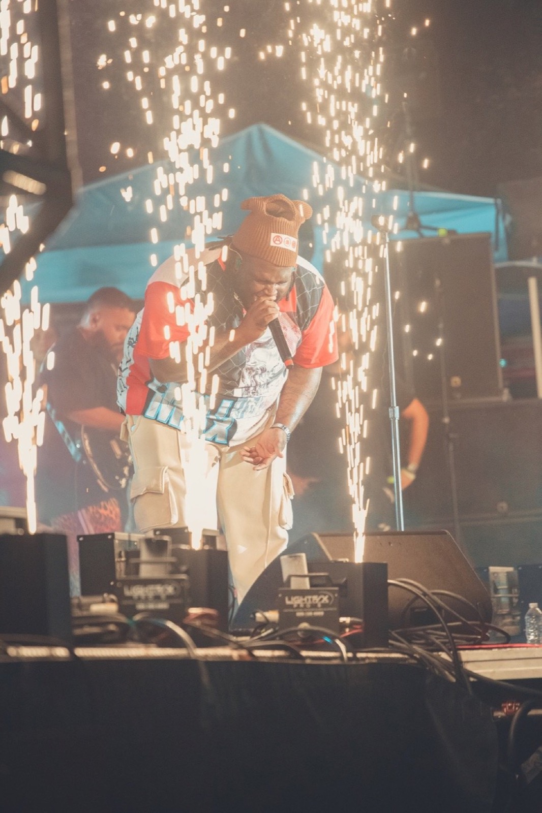 Artist under fireworks on stage